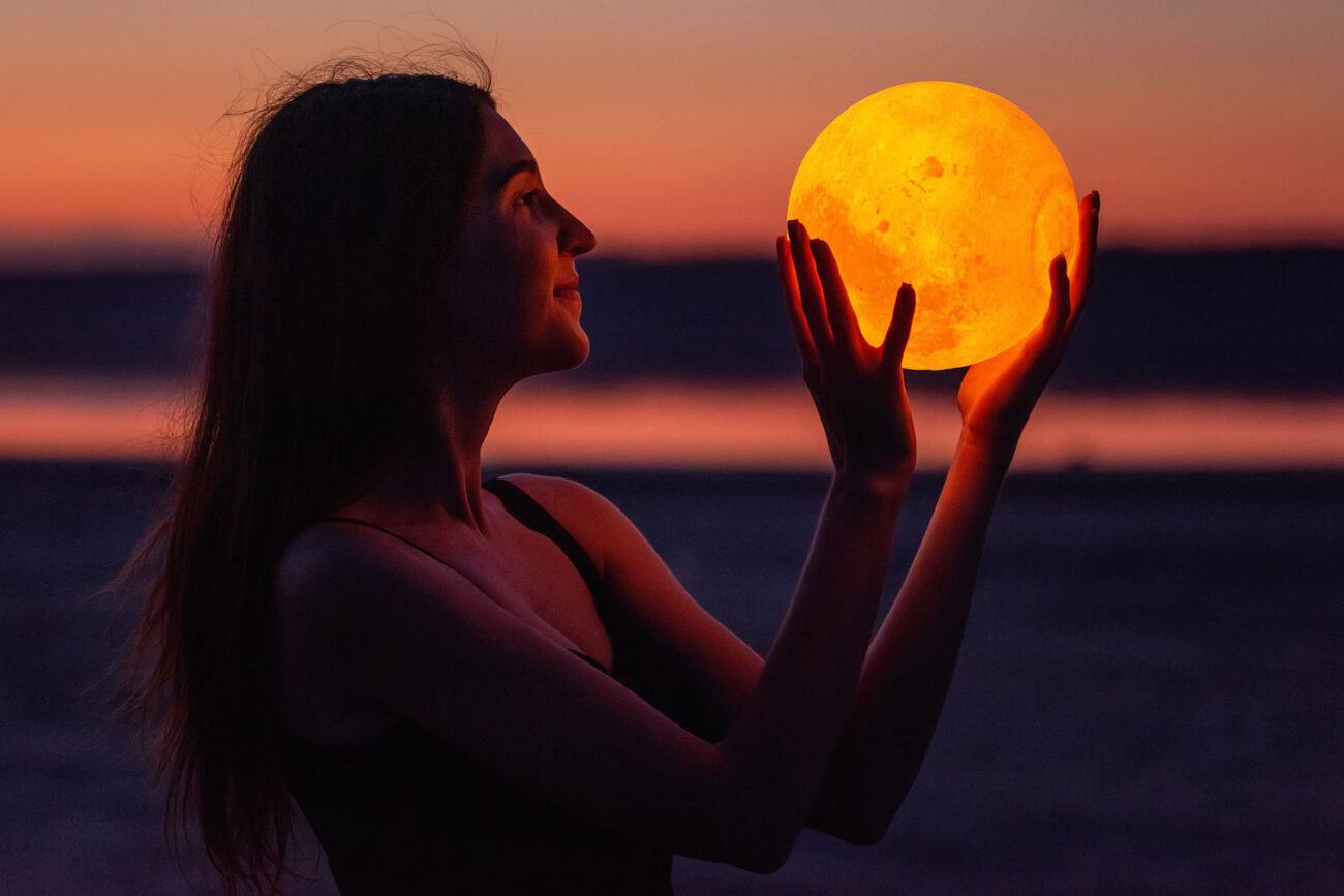 a-young-woman-holds-the-full-moon-in-her-hands-aga-2022-11-15-08-51-18-utc.jpg